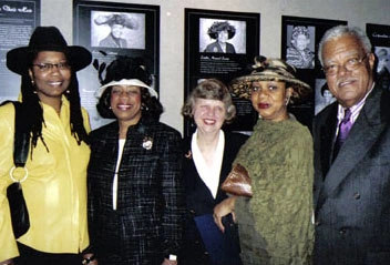 Uncrowned Queens members and other people at the Uncrowned Queens in Their Hats exhibit.