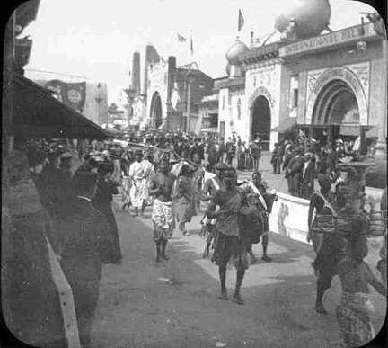 Crowd dressed in traditional African attire at the Pan American Expo gates.
