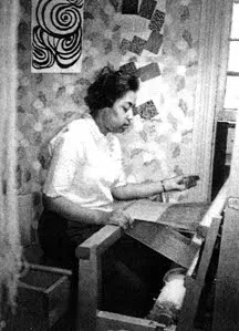 at work on her loom.